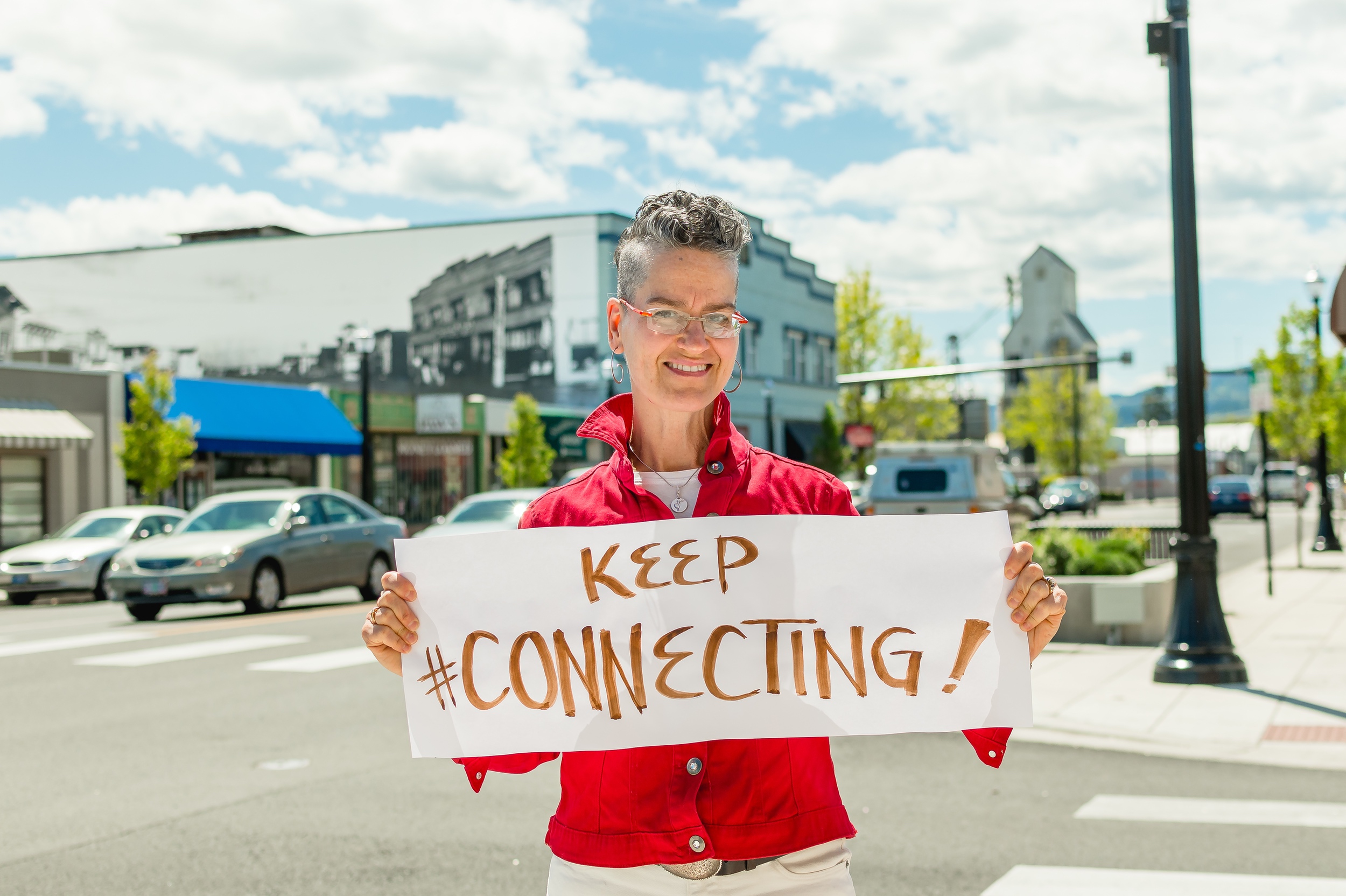 Ginger Johnson with sign, "Keep Connecting!"